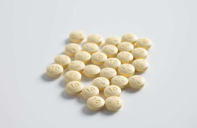 round yellow medication pill lot